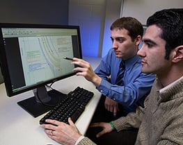 team members working together, working infront of a computer, tcc curve, tcc curve on computer monitor